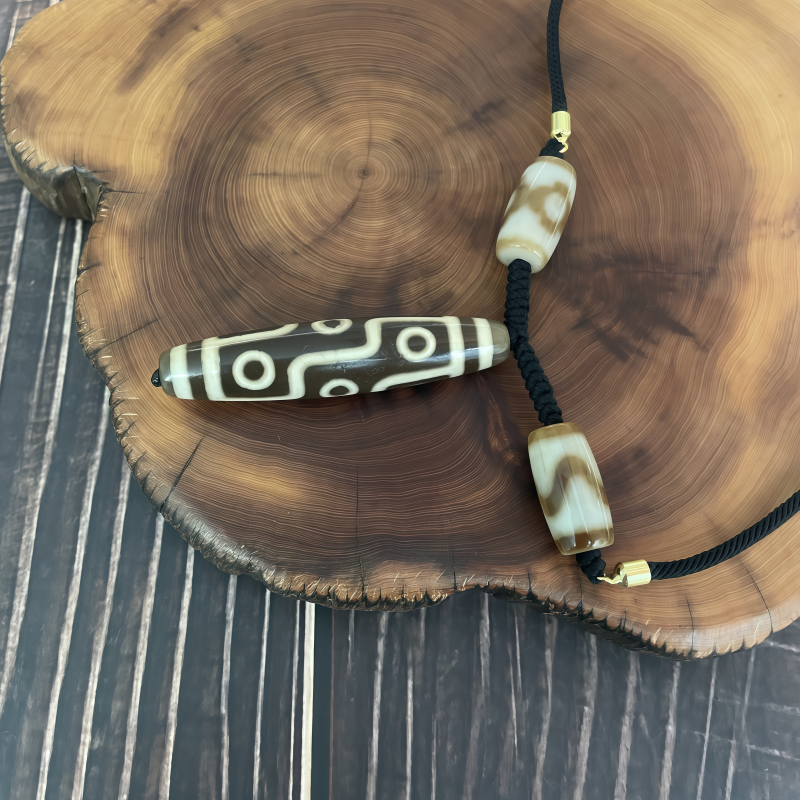 牙黄折线九眼天珠-竖款-男女通用